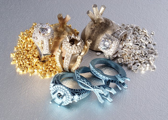 Selection of fine jewelry metals at Kaz Jewelry, including platinum, yellow gold, white gold, and rose gold used in custom engagement rings and timeless designs.